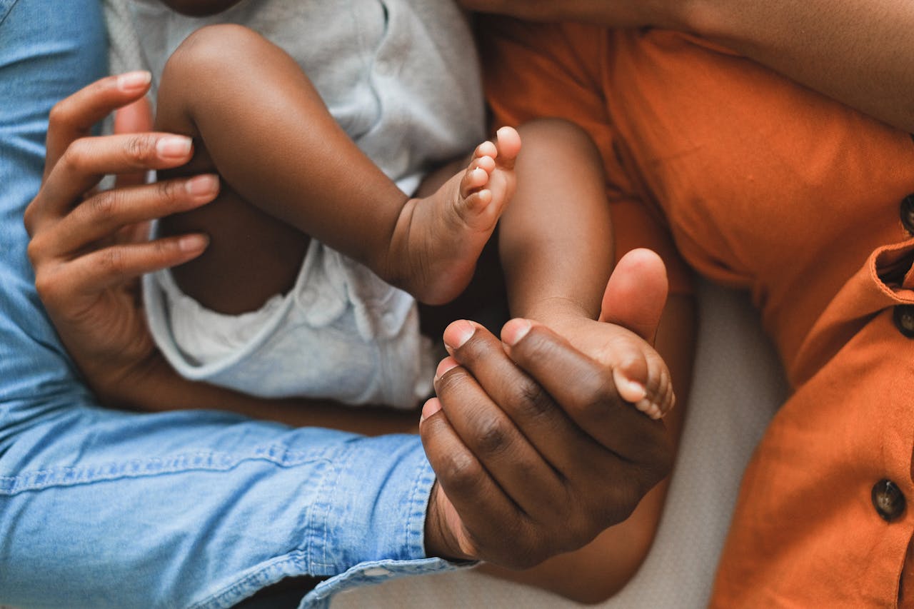 Home Close-up of a family holding a baby, showcasing love and connection.